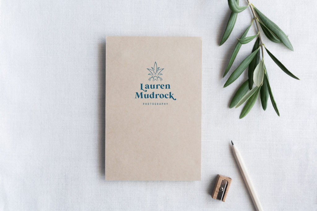 Logo on a book with words "Lauren Mudrock" under a pineapple illustration.
