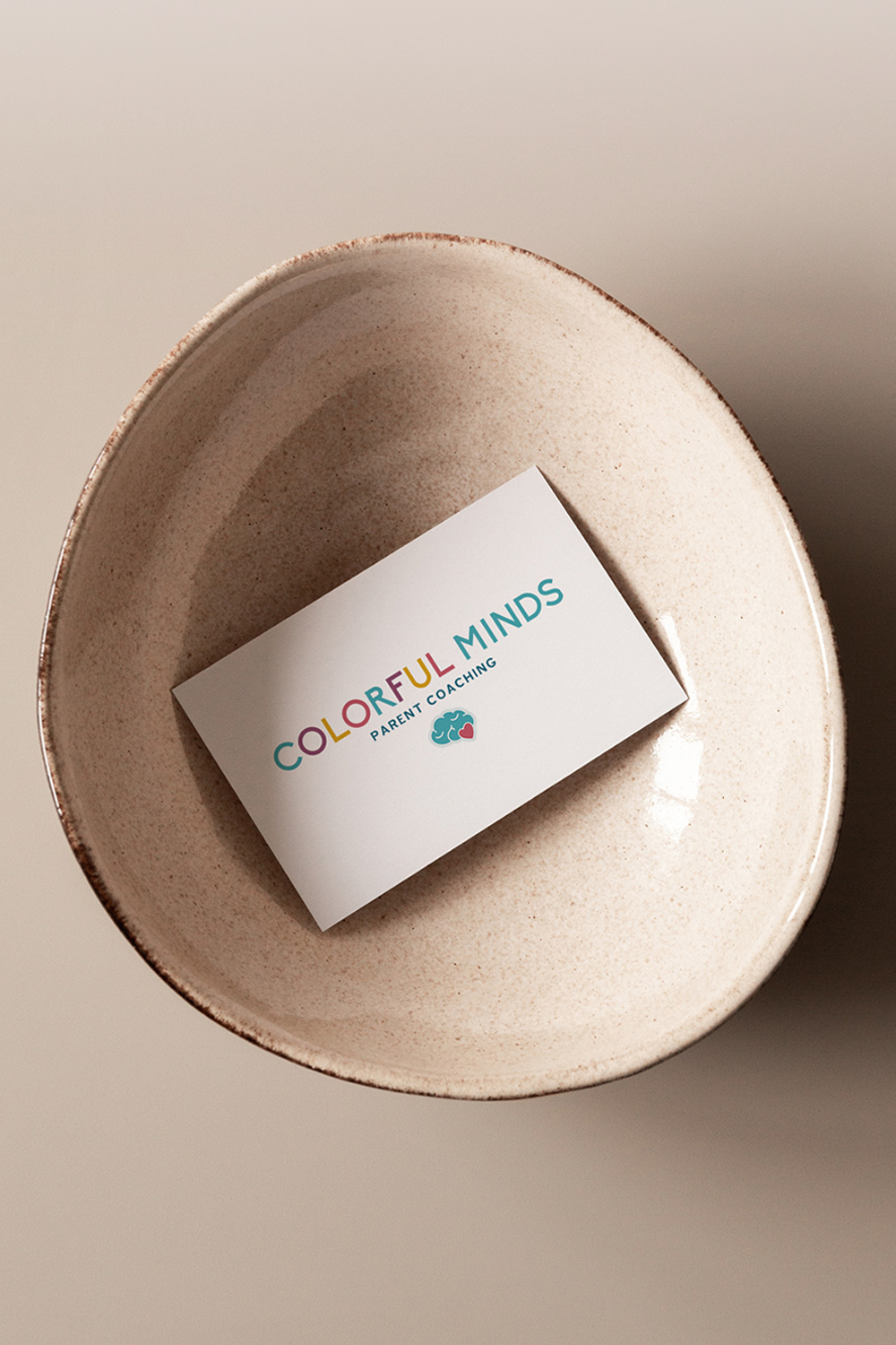 Business card with colorful minds logo in ceramic bowl