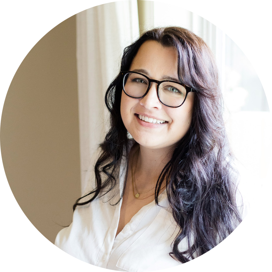 Aubre Walther smiling as she stands in front of a sunlit window.